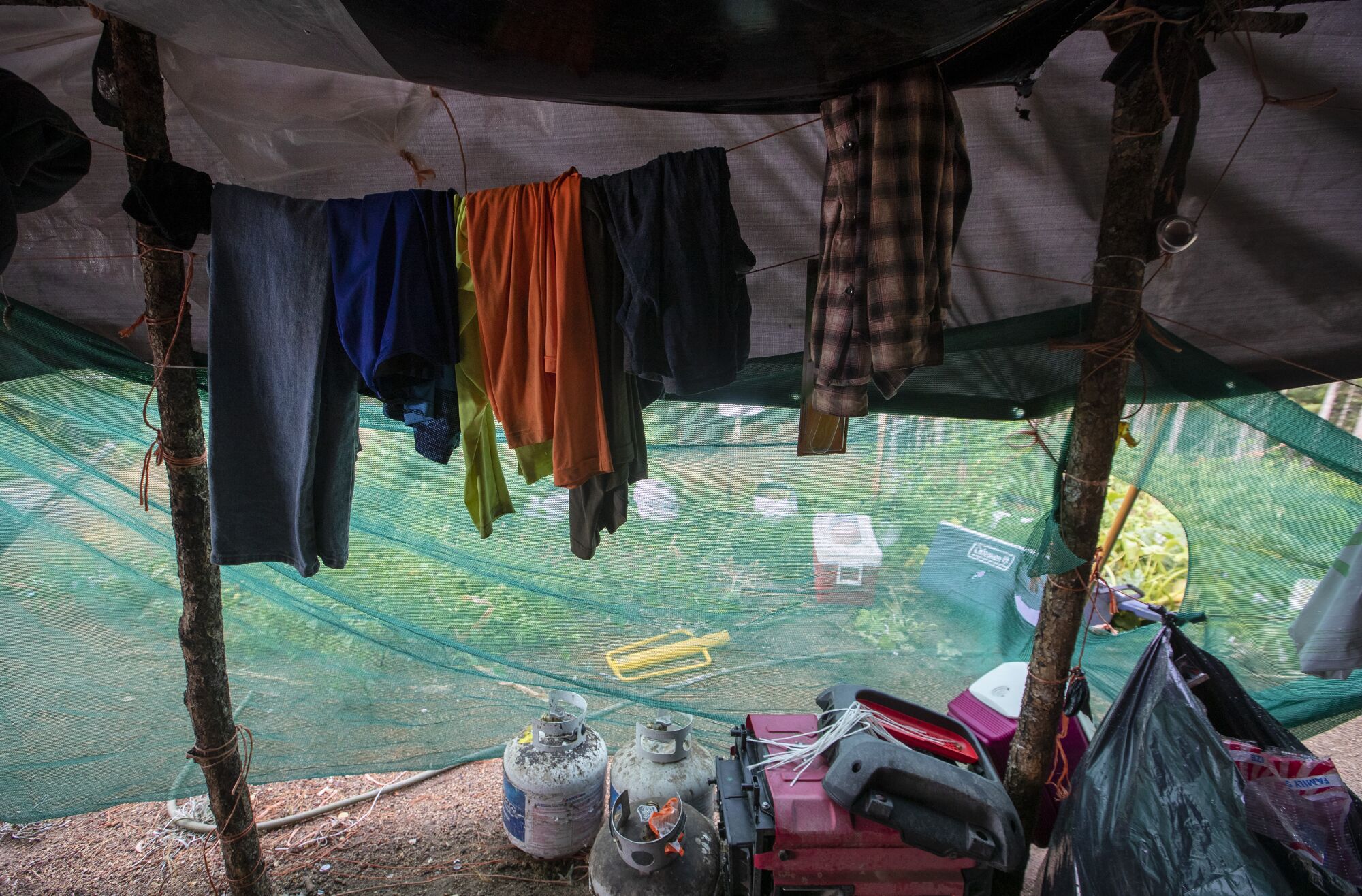 Clothes hang on a line in makeshift living quarters on an illicit grow. 